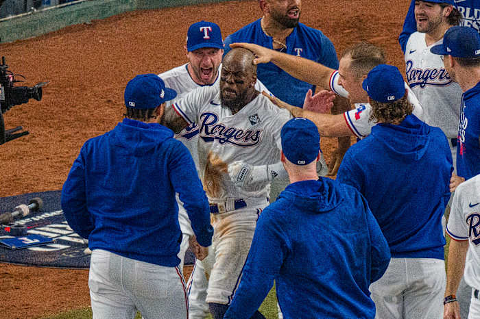 Oct 27, 2023; Arlington, Texas, USA; Texas Rangers starting pitcher Max Scherzer (31) and first baseman Nathaniel Lowe (30) celebrate after right fielder Adolis Garcia (53) hits a walk-off home run to defeat the Arizona Diamondbacks during the eleventh inning in game one of the 2023 World Series at Globe Life Field. Mandatory Credit: Jerome Miron-USA TODAY Sports